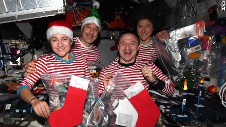 (From left) Meir, Parmitano, Morgan and Koch are celebrating Christmas in space - in matching pajamas.